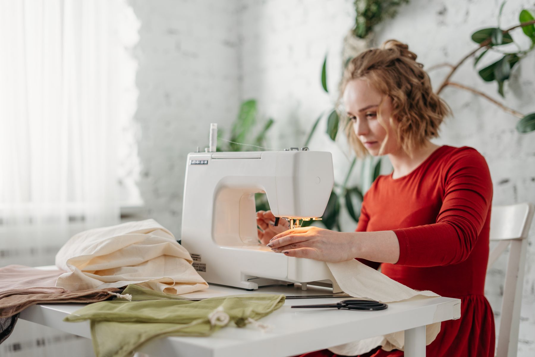 Member sewing at a reserved studio bench